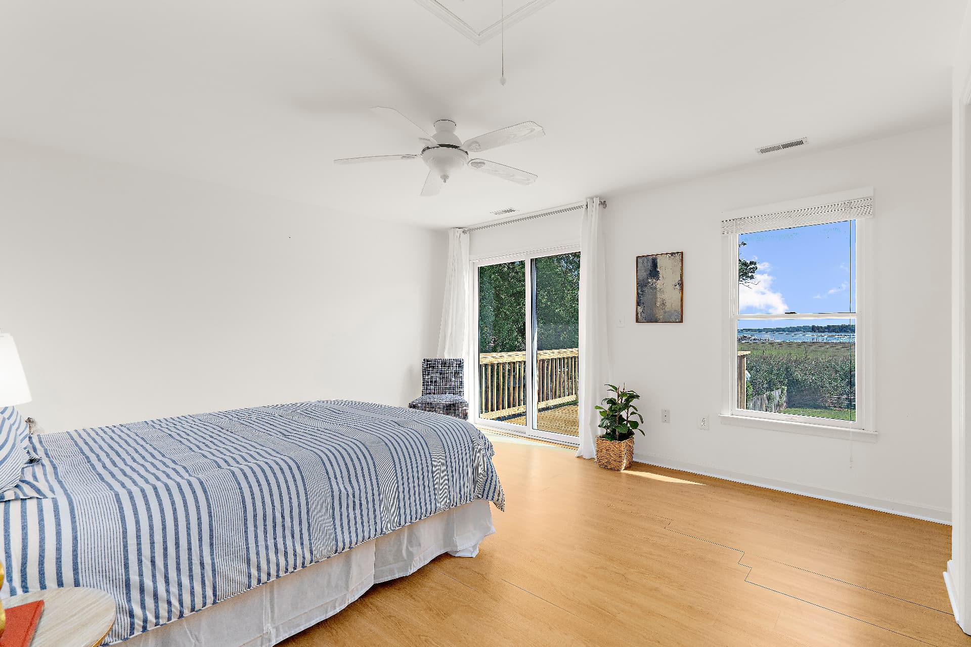 Primary bedroom opening to private deck with water view