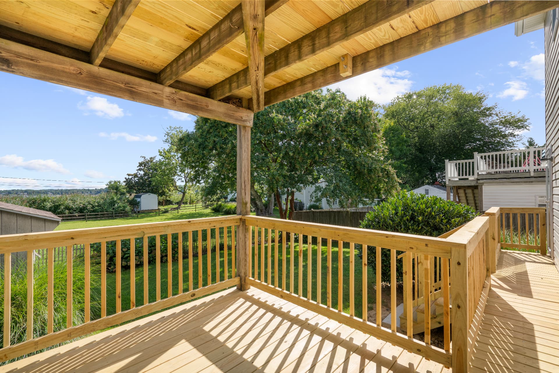 Newly renovated rear deck with grill and water view